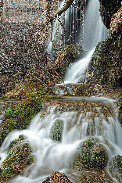 Waterfalls over jutting rocks at the source of the Cuervo river in Guadalajara  Spain.