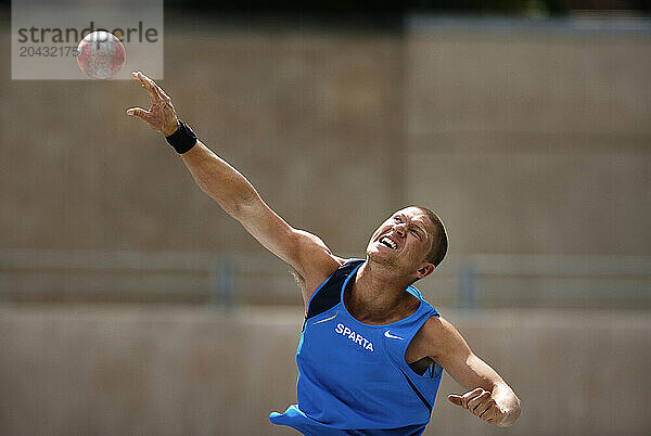 Athlete doing a shot put at Osterbro Stadium in Copenhagen.