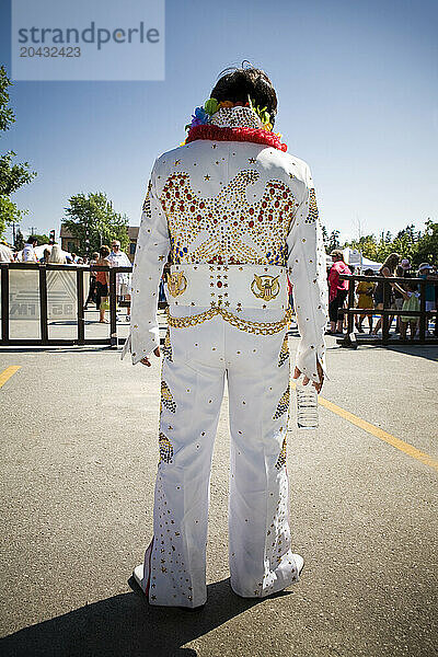 Elvis impersonator in a white suit.