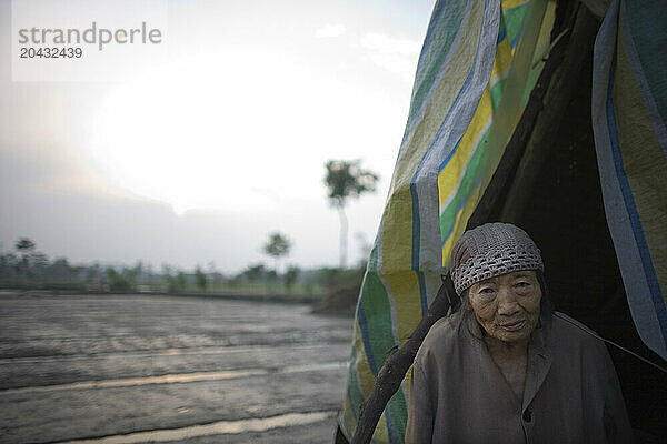 A woman looks out from her tent following an earthquake in Sichuan  China.