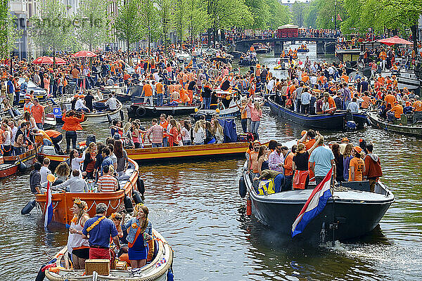 Revelers dressed in orange filled Amsterdam's canals in boats to celebrate King's Day.