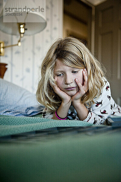 a girl in her pj's is deep in thought