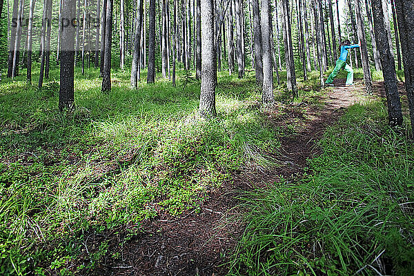 A woman stretches before trail running in Glacier National Park.