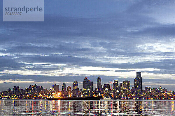 A city waterfront skyline at sunrise.