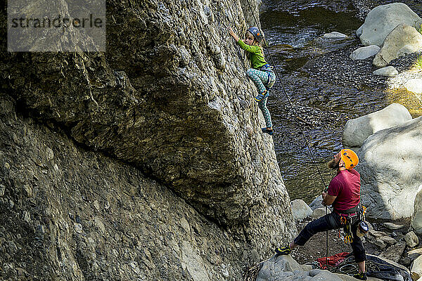 Father watching daughter rock climbing at Wheeler Gorge