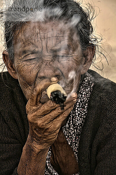 snuff woman smoking a Pagan market