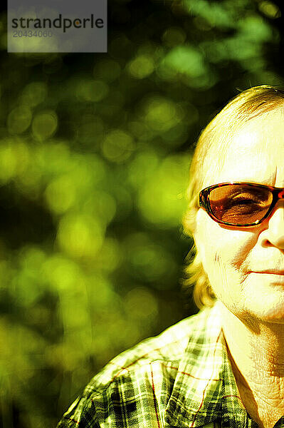 A profile shot of just half of a face of an older woman outside.