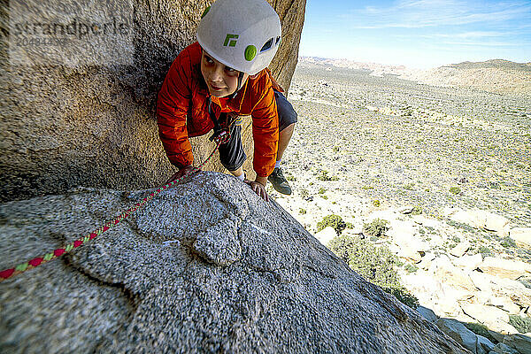 Boy rock climbing in Joshua Tree National Park