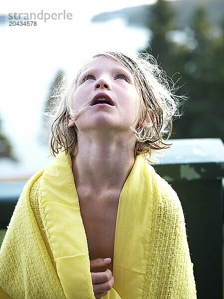 girl  wrapped in a blanket  looks up to the sky