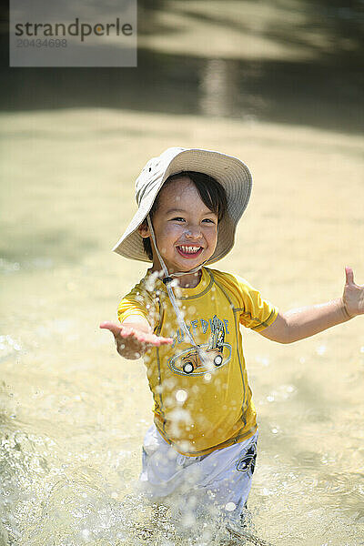 A little boy plays in Eli Creek  on Fraser Island  Australia