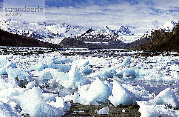 Ice lying in front of snowcapped hills