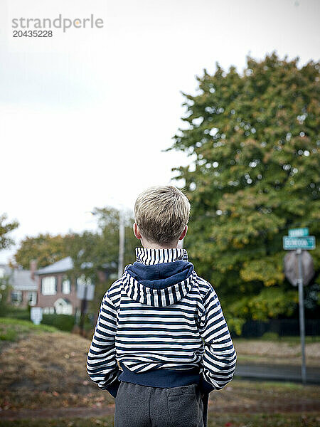 boy looks down street