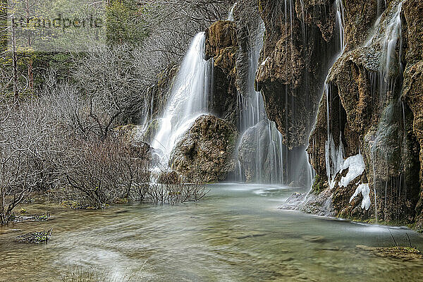 Waterfalls over jutting rocks at the source of the Cuervo river in Guadalajara  Spain.