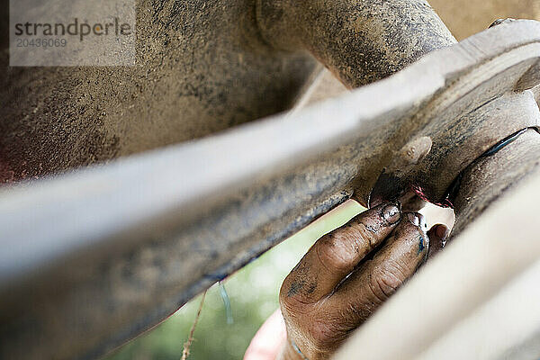 Farmer hand and machinery.