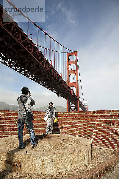 A young couple takes photos as they explore Fort Point in San Francisco. Feb. 2010