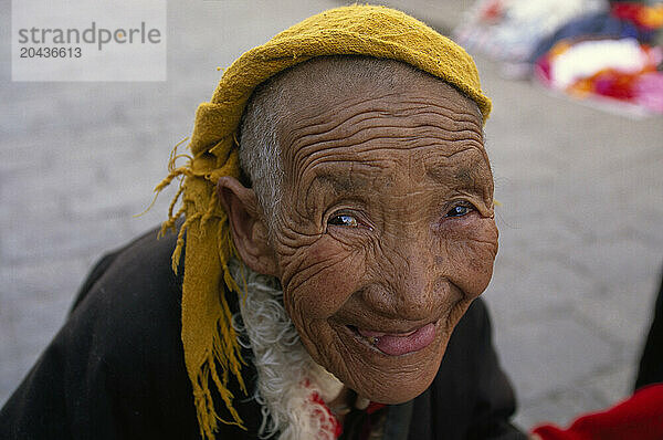 A Buddhist pilgrim smiles into the camera in Lhasa  Tibet.