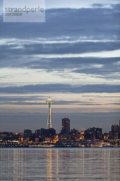 A city waterfront skyline at sunrise.