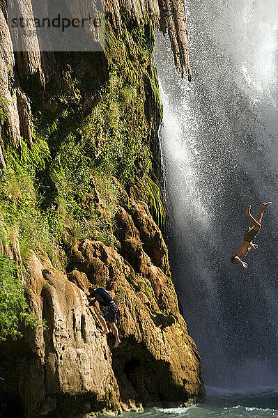 A man flips into a waterfall in the Grand Canyon  Arizona