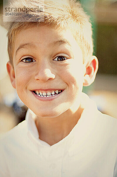 a young boy smiling with funny face.