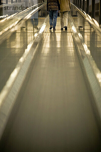 Couple on a moving walkway in Wolfsburg  Germany