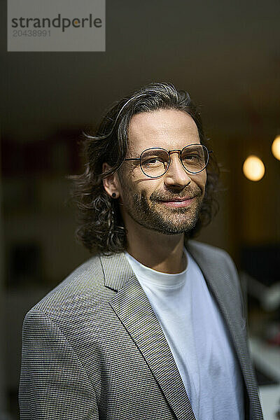 Smiling handsome businessman wearing eyeglasses at office