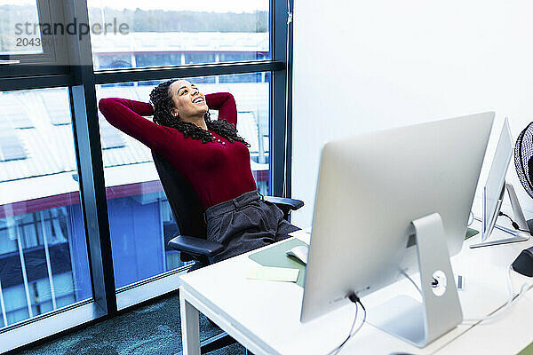 Carefree businesswoman relaxing on office chair