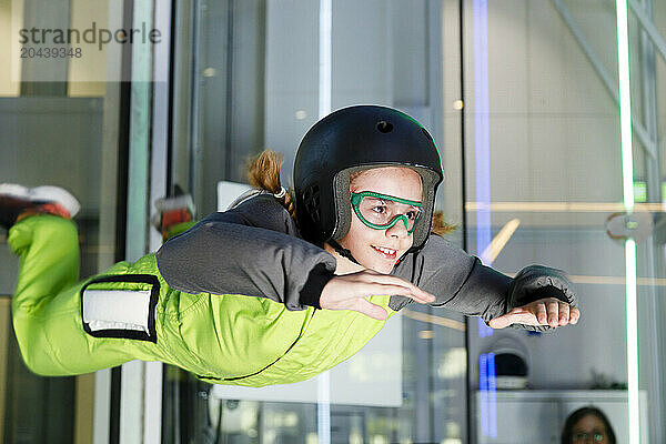 Smiling girl experiencing skydiving at center