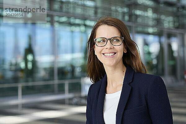 Smiling businesswoman wearing eyeglasses at airport