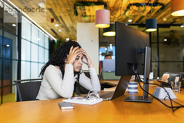 Tired businesswoman with laptop at desk in office