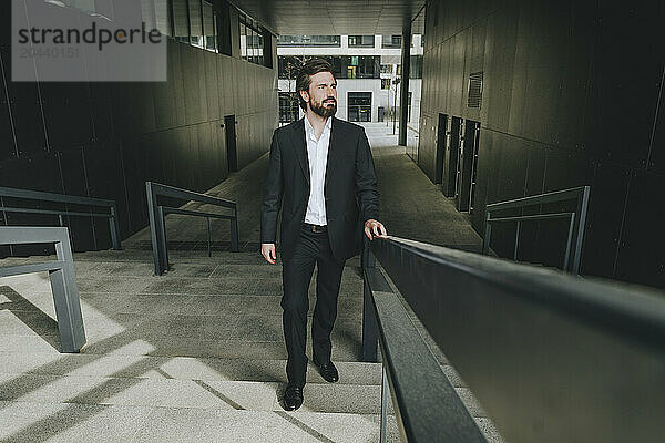 Businessman moving up stairs in office building