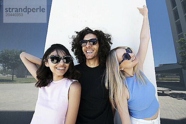 Friends wearing sunglasses and enjoying at university campus