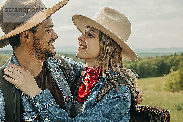 Happy couple wearing hats embracing each other