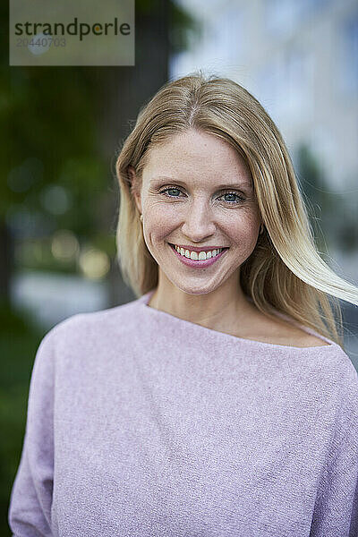 Happy woman wearing purple sweater