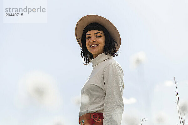 Happy young woman wearing hat