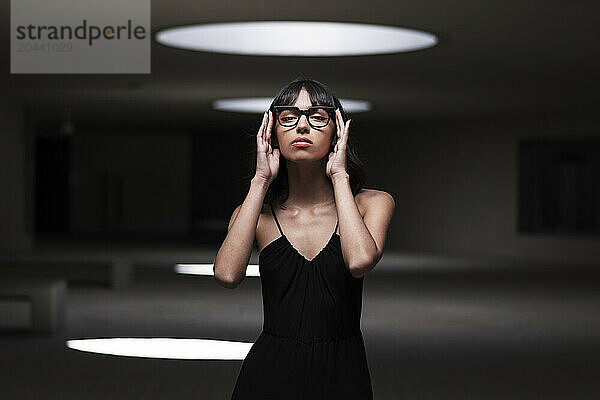 Confident young woman wearing eyeglasses