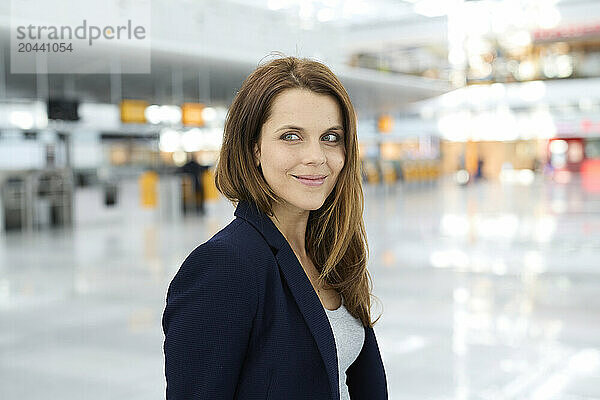 Smiling businesswoman with brown hair at airport