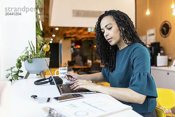 Businesswoman with curly hair working at office