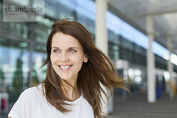 Smiling woman with brown hair at airport