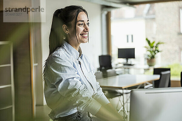 Smiling businesswoman standing at office