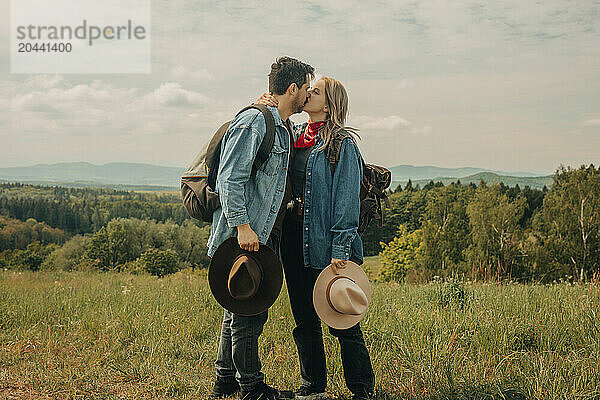 Couple on vacation standing and kissing