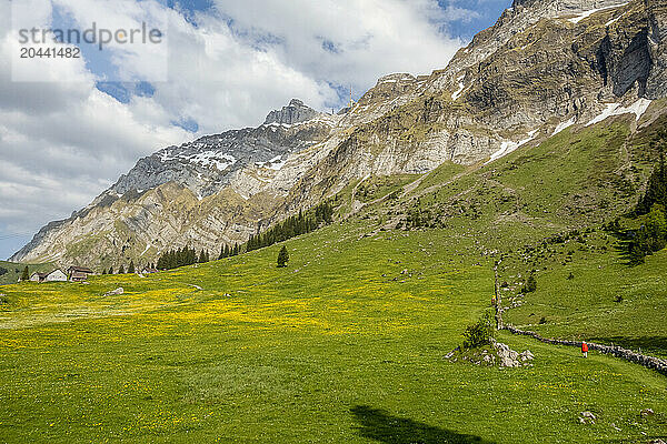 Senior woman hiking towards Santis mountain in Switzerland