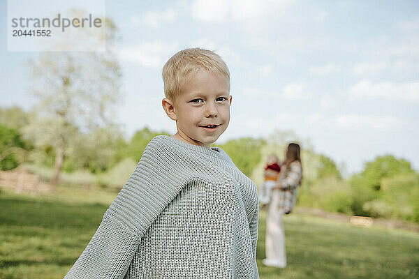 Blond hair boy standing at farm