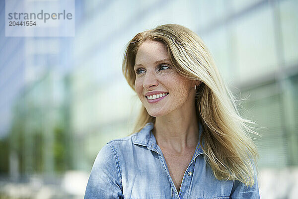 Beautiful blond hair woman wearing denim shirt