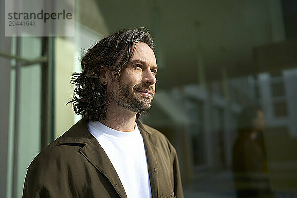 Handsome mature man with stubble looking away