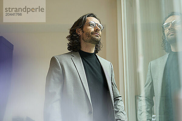 Confident mature businessman wearing eyeglasses at office