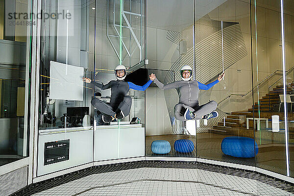 Instructors practicing and levitating at indoor skydiving center