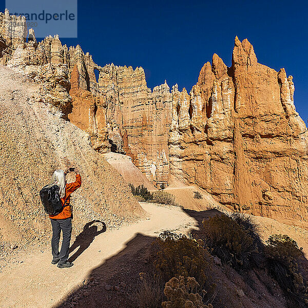 Rear view of woman taking pictures in Bryce Canyon National Park