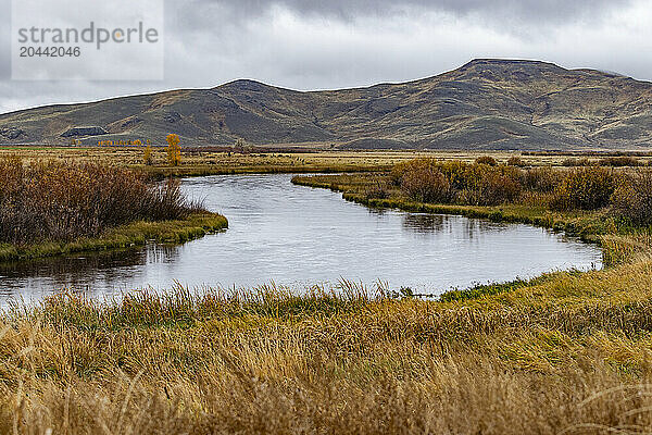 Quiet waters of Silver Creek with mountains in distance