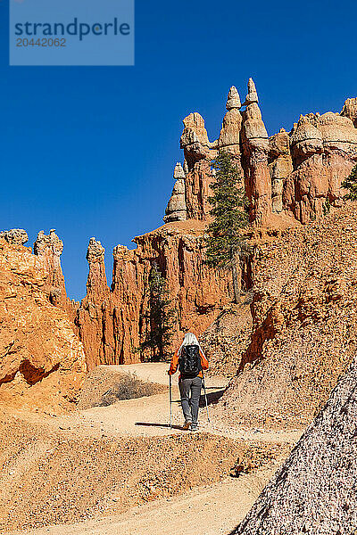 Rear view of woman with backpack hiking in Bryce Canyon National Park