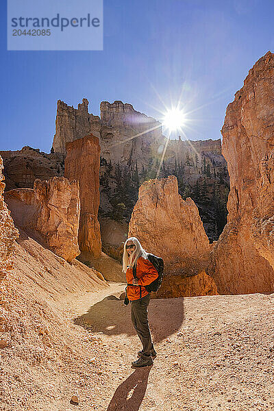 Portrait of smiling woman hiking in Bryce Canyon National Park on sunny day